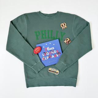 Jupmode Philly Crewneck Sweatshirt styled with a 76ers Legends Alphabet Book, Hoagie Money Pouch, Hoagie Sticker, and Pretzel Hair Clips on Design Life Kids.